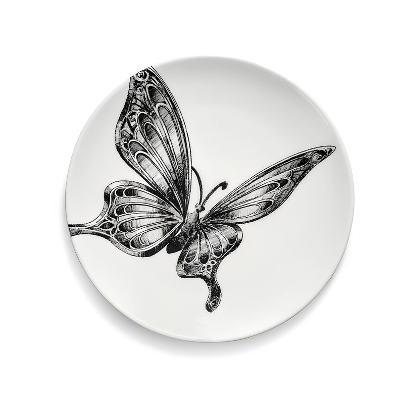 Brotteller UNITY mit Schmetterling. Er hat einen Durchmesser von 12 cm und eine Höhe von 1 cm und ist von Serax. Das 4er Set wird geliefert  in einer Geschenkbox.